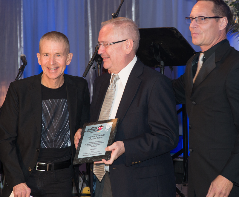 Murray Archibald (l-r) and Steve Elkins accept an appreciation plaque for 25 years of dedicated service to Create a More Positive Rehoboth from Chris Beagle. BY DENY HOWETH